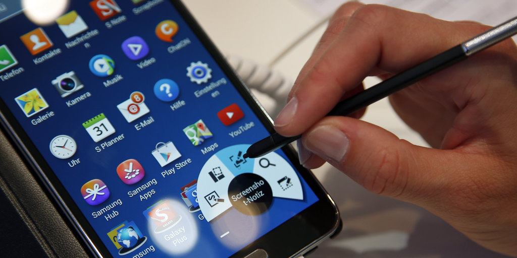 A woman uses a Samsung Galaxy Note 3 Smartphone at the IFA, one of the world's largest trade fairs for consumer electronics and electrical home appliances in Berlin, Germany, Friday, Sept. 6, 2013. (AP Photo/Michael Sohn)