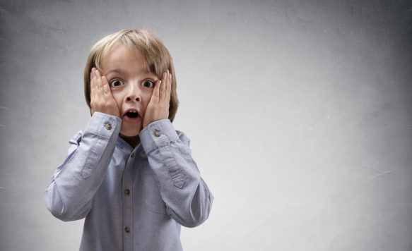 Shocked and surprised boy with copy space concept for amazement,
